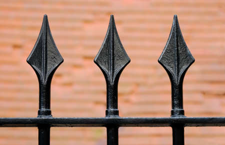 Black Iron fence with three spikesの写真素材
