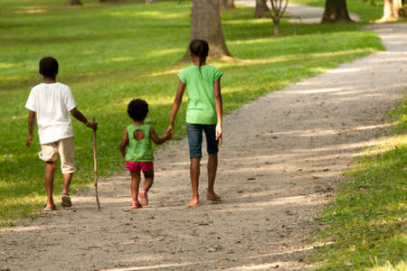 African-American children walking along a gravel pathの写真素材