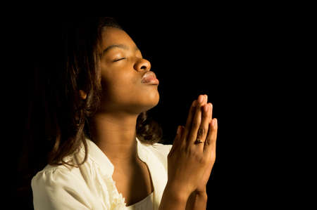 An African American girl prays to God.の写真素材