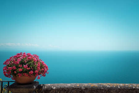 Pink flowers and bird-eye view at sea from villa Chimbrone. Amazing background for your designの写真素材