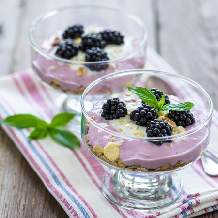 Homemade desert with berries and mint on the table for your designの写真素材