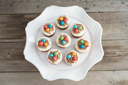 Easter cupcakes with chocolate frosting and candy eggsの写真素材
