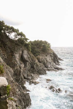 Small storm near the rocky shore of the Ligurian seafront.の写真素材