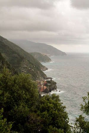High forested mountains and stormy sea under the low clouds.の写真素材
