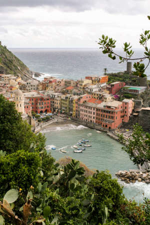 View of an Italian fishing village with colored houses and the harbor on a rainy day.の写真素材