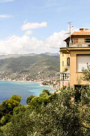 Ligurian coast - the mountains, villages and beaches. In the foreground - the yellow house and garden.の写真素材
