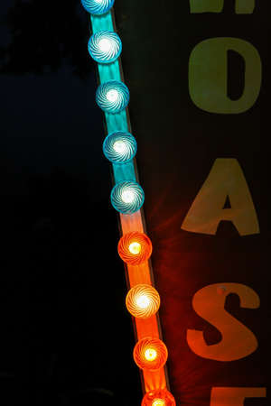 Mysterious and bright red and blue lights garlands with circus posters.の写真素材