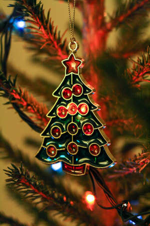 Christmas toy on the Christmas tree among the garlands and streamersの写真素材