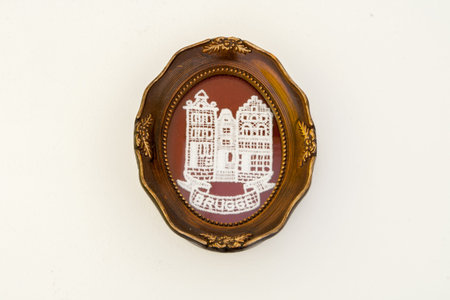 Tourist souvenir oval metal plate from Bruges with white lace.の写真素材