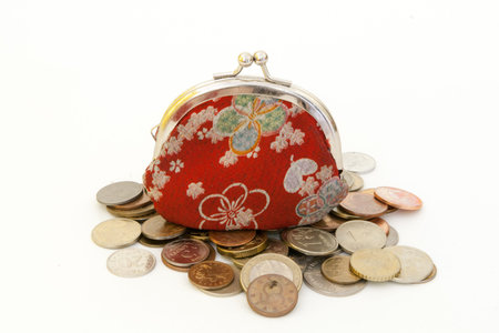 Old fashioned red purse with flowers, and coins.の写真素材