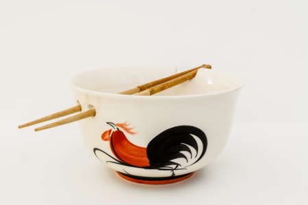Deep white ceramic bowl with holes for sticks and drawingsの写真素材
