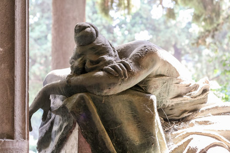 Statue of a grieving girl on monumental cemetery of Staglieno in Genoa.の写真素材