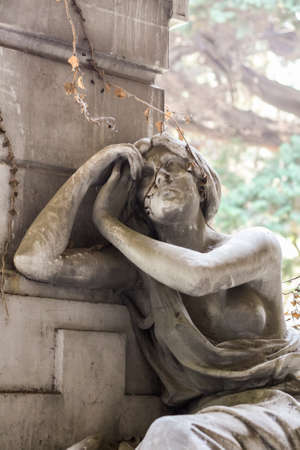 Statue of a grieving girl on monumental cemetery of Staglieno in Genoa.の写真素材