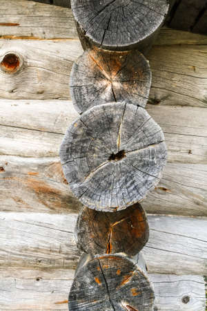The ends of the logs of the old wooden frame house.の写真素材
