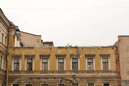 Facade of the destroyed classic yellow house.の写真素材
