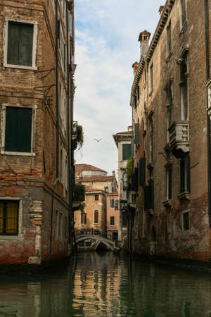 Venetian narrow canal among classical shabby housesの写真素材