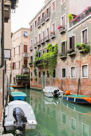 Venetian narrow canal among classical shabby housesの写真素材