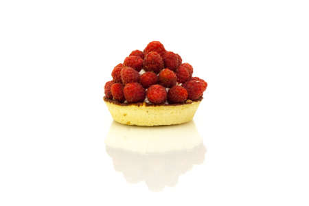 Tartlet pastry with cream and fresh raspberries with reflection on white background.の写真素材