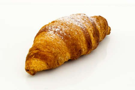 Croissant with powdered sugar on white background.の写真素材