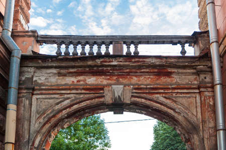 Old classic arch with balustrade against the sky summer eveningの写真素材