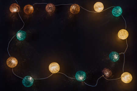 Electric garland with wire balls on a dark backgroundの写真素材