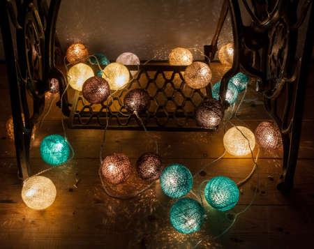Electric garland with wire balls on the board and cast ironの写真素材