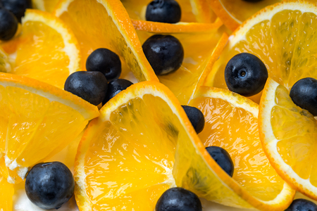 Sliced ??orange fruit and blueberry close up view from directly aboveの写真素材