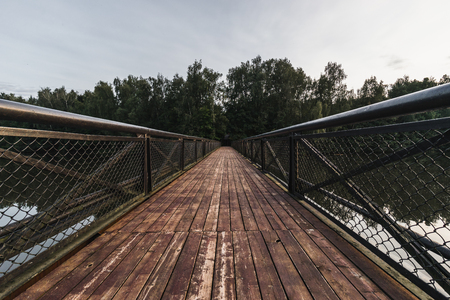 Old faded wooden bridge perspective viewの写真素材