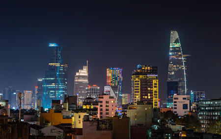 HO CHI MINH, VIETNAM - NOVEMBER 22, 2017: Urban night skyline view of Ho Chi Minh city. Front view on colored skyscrapers in downtownのeditorial素材