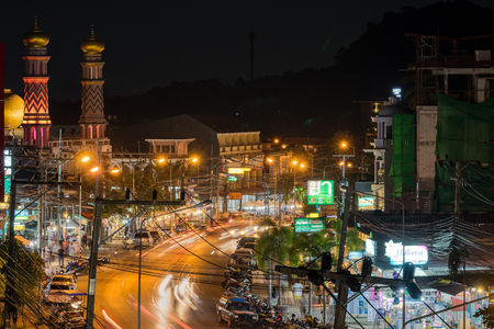 Ao Nang, Krabi Province, Thailand - January 21, 2019: Muslim temple, hotels, restaurants and markets on local main street and lights of transport on road in the night. Long exposure shotのeditorial素材