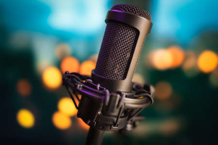 Professional studio microphone on blurred bokeh lights backgroundの写真素材