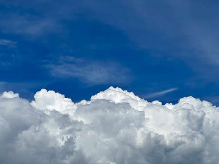 White cumulus clouds on blue sky. background with copy spaceの写真素材