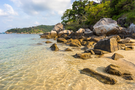 Famous scenic empty tropical paradise Freedom Beach on Koh Tao island with stones and rocks on shore and in pure crystal water in sunny morning - top travel destinations for vacations in Thailandの写真素材