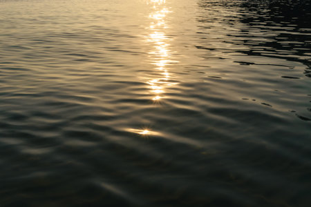 Liquid dark sea water surface rippled texture minimalistic abstract unfocused background with...