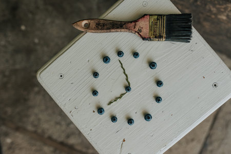 Fresh blue matte round blueberries. on wooden white chairs lie berries folded in a circle in the...