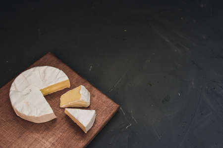 cheese camembert with mold on the wooden cutting boardの写真素材