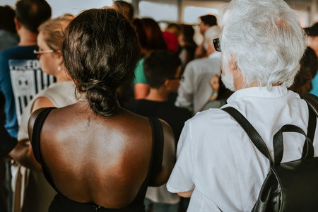 An old man with white gray hair in a snow-white shirt stands next to a black woman with black hair...