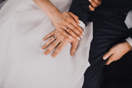 man and woman holding hands. wedding rings bride and groom on the background. Wedding ceremony....