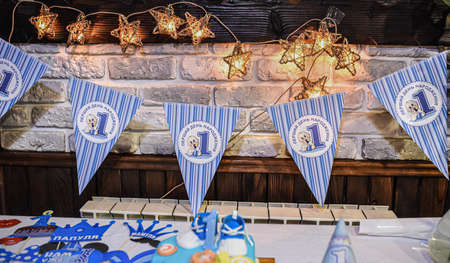 White-blue decoration in honor of the child birthday. a childrens party for a boy. Inscriptions: First birthday. Daddy. Mommy.の写真素材
