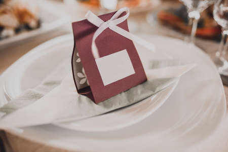 Card with the inscription of the guests name for serving on the festive table on a white plateの写真素材