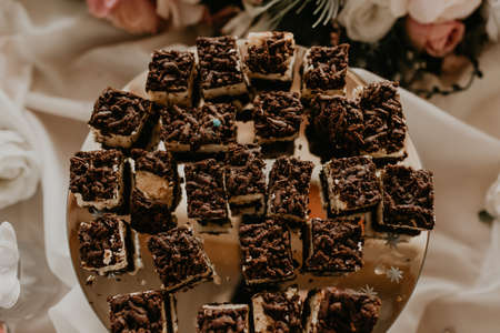 Portion cut chocolate cakes desserts on plates Sweet catering on the table.の写真素材