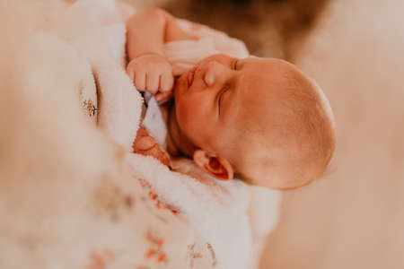 rite sacrament of epiphany child baby in church. A mother is holding a newborn child in her arms.の写真素材