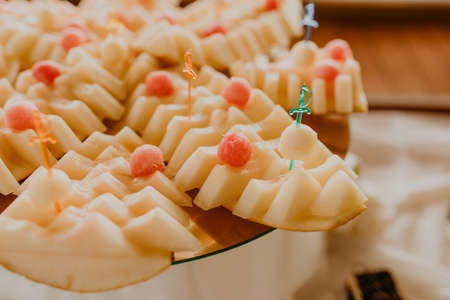 sliced fresh melon spread out on a plate for a buffet tableの写真素材
