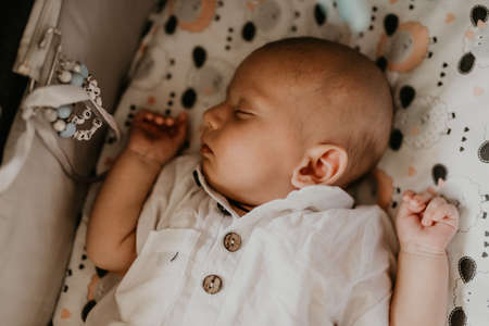 Child baby newborn baby boy asleep in cribの写真素材