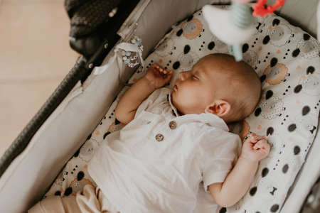 Child baby newborn baby boy asleep in cribの写真素材