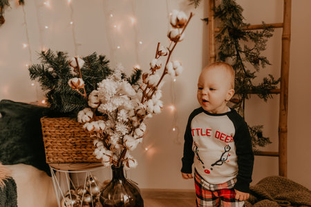 Baby girl in pajamas in the bedroom. Christmas morning. New Year's interior. Valentine's day...