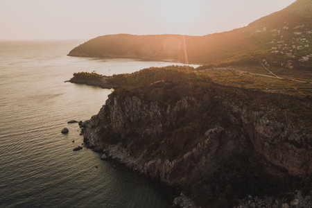 Aerial top evening view drone above Adriatic sea in Montenegro. panoramic sunny marine mountain...