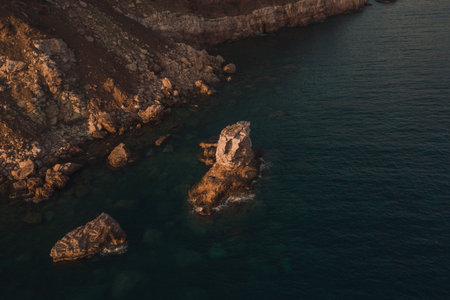 Aerial top evening view drone above Adriatic sea in Montenegro. panoramic sunny marine mountain sunset. summer nature wallpaper. dark calm water rock. mountains coast seaside. Amazing outdoors viewの写真素材