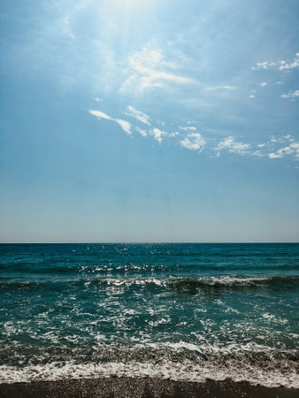 Sea blue aquamarine waves line sunny sand beach. Soft wave of ocean foam. Natural background sky. Template free space pattern wallpaper mockup. Summer background Black sea waves marine beachの写真素材