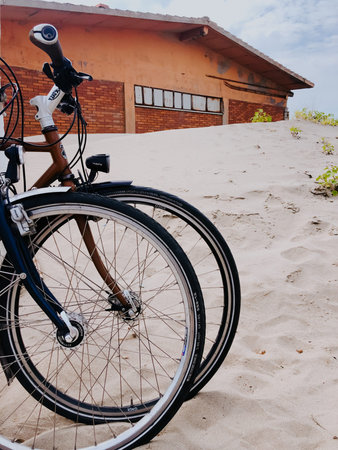 two sports bikes stand side by side on white sandy beach. Template free space pattern wallpaper...
